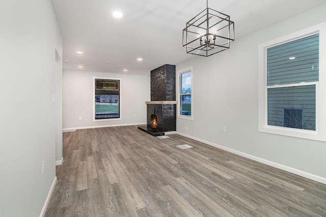 unfurnished living room with a fireplace and wood-type flooring