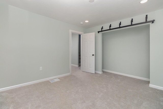 unfurnished bedroom with light carpet