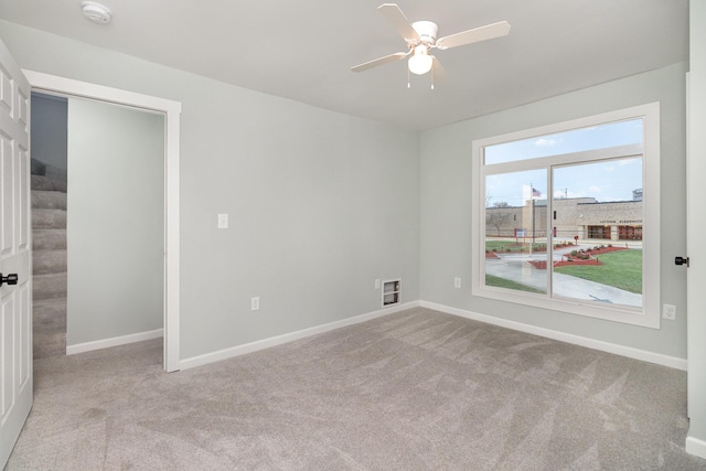 empty room with ceiling fan and light colored carpet