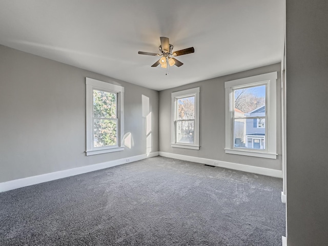 carpeted spare room with ceiling fan