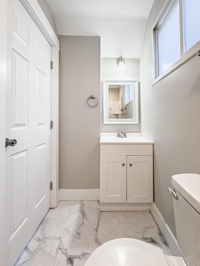 bathroom featuring vanity and toilet