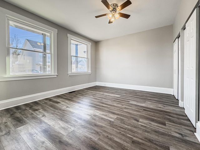 unfurnished bedroom featuring ceiling fan and dark wood-type flooring