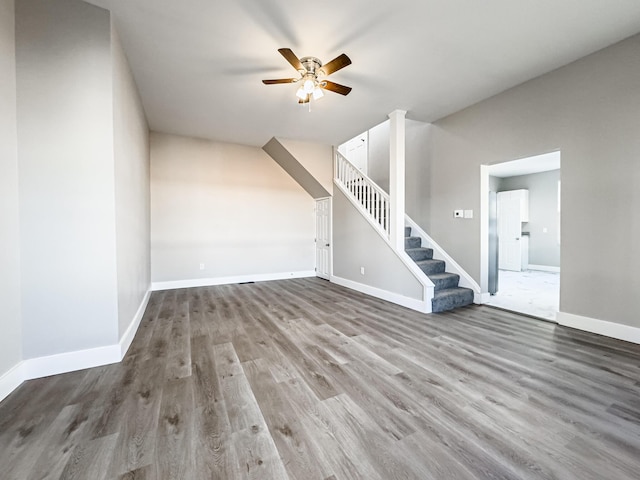 unfurnished living room with hardwood / wood-style floors and ceiling fan