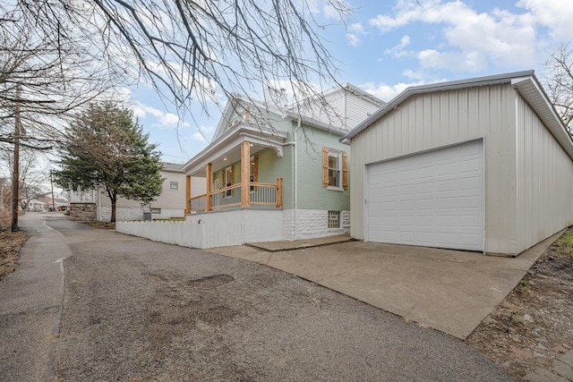 view of front of house featuring a garage and a porch