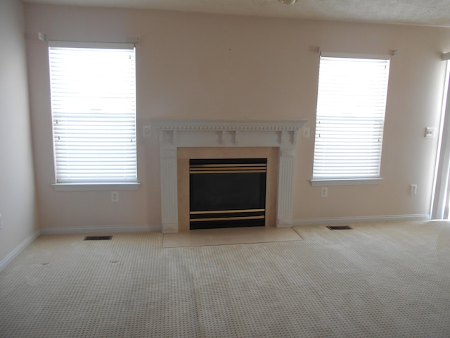 unfurnished living room featuring light colored carpet