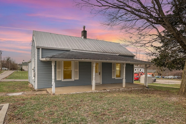 view of front of house with a yard and covered porch