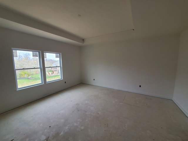 unfurnished room with baseboards