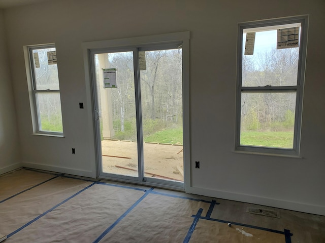 doorway to outside with baseboards