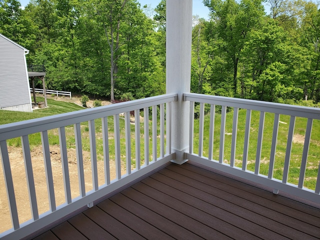 wooden deck with a lawn