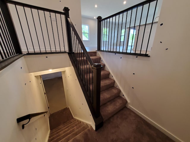 stairway with carpet flooring, baseboards, and recessed lighting