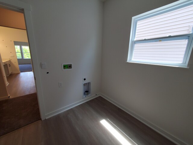 laundry room featuring electric dryer hookup, wood finished floors, hookup for a washing machine, and baseboards