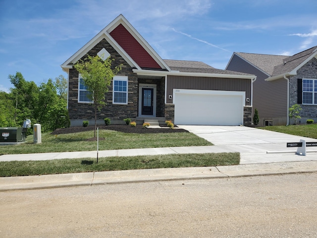 craftsman-style house featuring stone siding, a garage, concrete driveway, and a front lawn