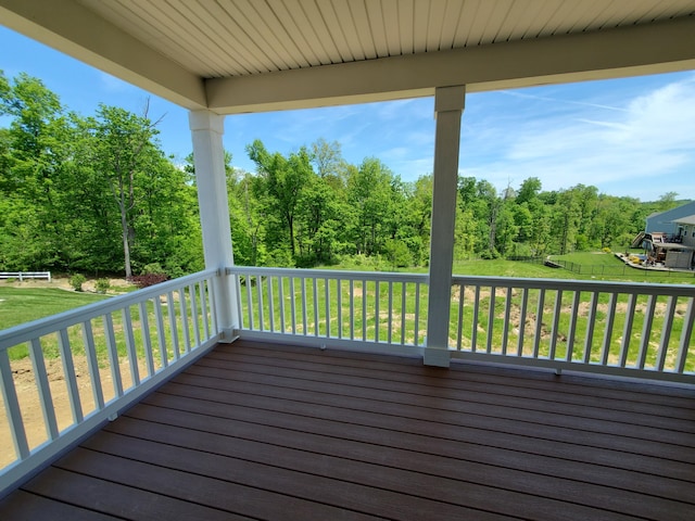 wooden terrace with a yard