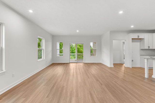 2516 Winners Post Way, Burlington, KY 41005 - unfurnished living room with baseboards, recessed lighting, and light wood-style flooring