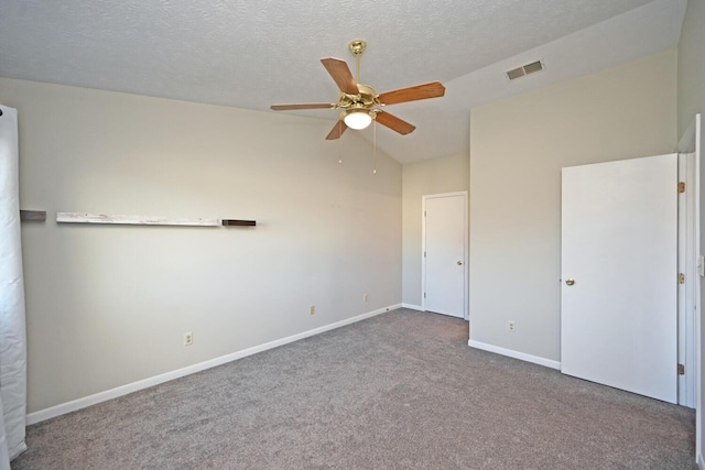 unfurnished bedroom featuring carpet flooring, ceiling fan, a textured ceiling, and vaulted ceiling