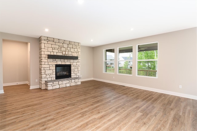 3850 Sherbourne Dr, Independence, KY 41051 - unfurnished living room featuring light wood-style floors, baseboards, a stone fireplace, and recessed lighting
