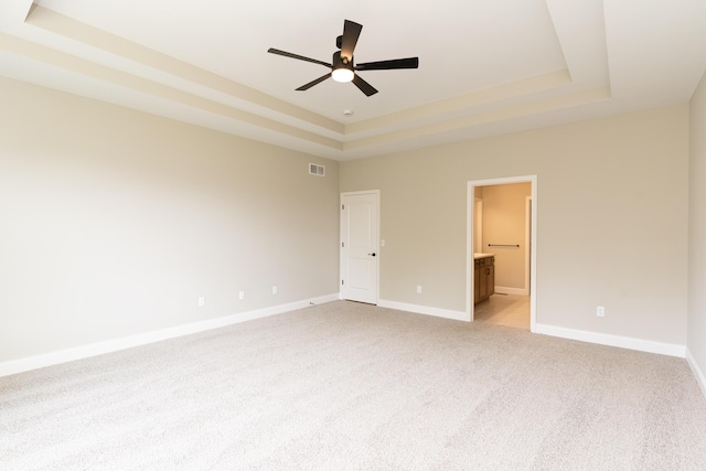 3850 Sherbourne Dr, Independence, KY 41051 - unfurnished bedroom featuring a raised ceiling, light colored carpet, baseboards, ensuite bathroom, and a ceiling fan