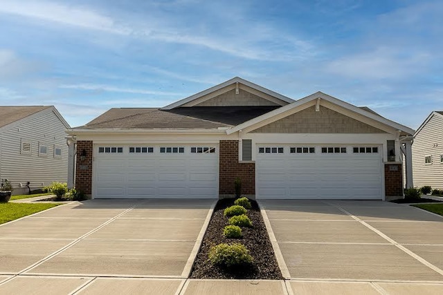 view of front of property featuring brick siding, a garage, and concrete driveway