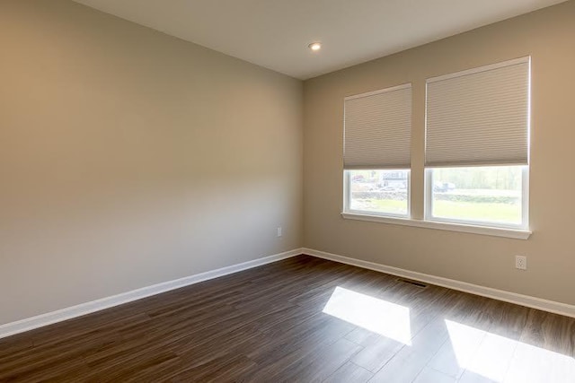 unfurnished room featuring recessed lighting, baseboards, and dark wood-style flooring
