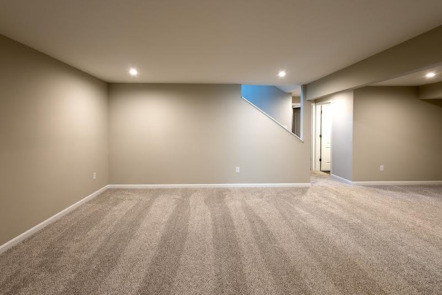 finished basement with recessed lighting, baseboards, and light carpet