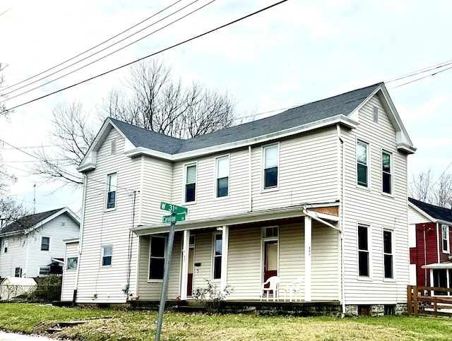 view of front of home with covered porch and a front yard