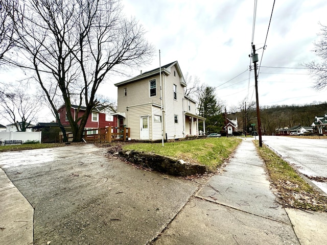 view of property exterior with a yard