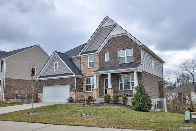 craftsman house featuring a front lawn and a garage