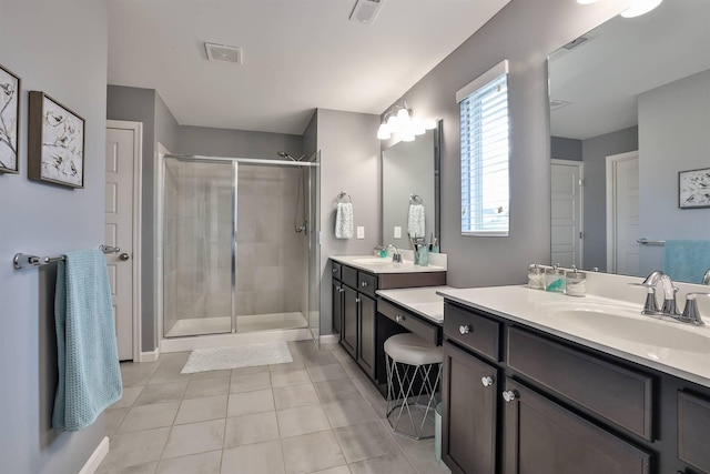 bathroom with vanity, tile patterned flooring, and an enclosed shower