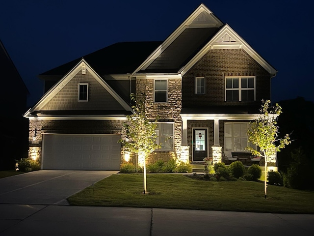 craftsman-style home with a garage and a yard