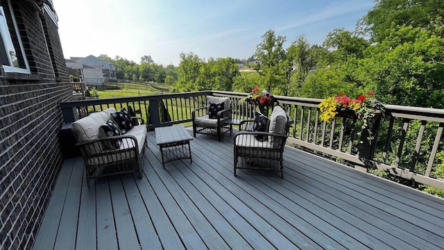 wooden deck with an outdoor living space