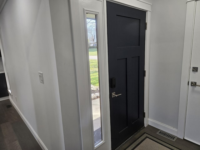 entryway with dark wood-type flooring