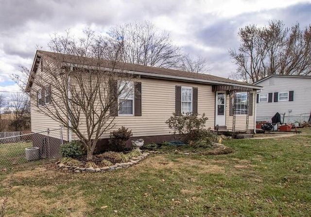 rear view of house featuring a yard