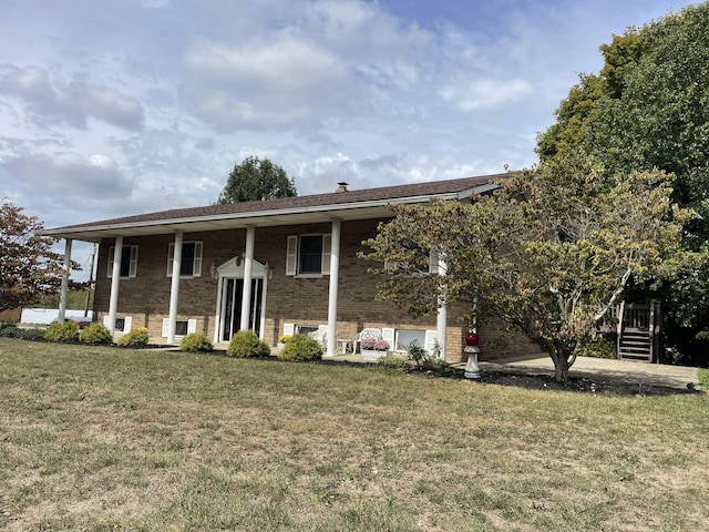 bi-level home with a front lawn