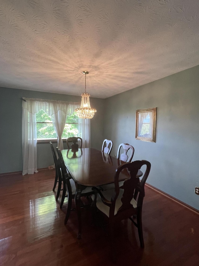 dining room featuring hardwood / wood-style flooring, a notable chandelier, and a textured ceiling