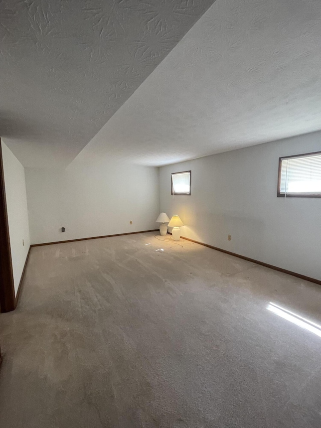 basement with carpet floors and a textured ceiling