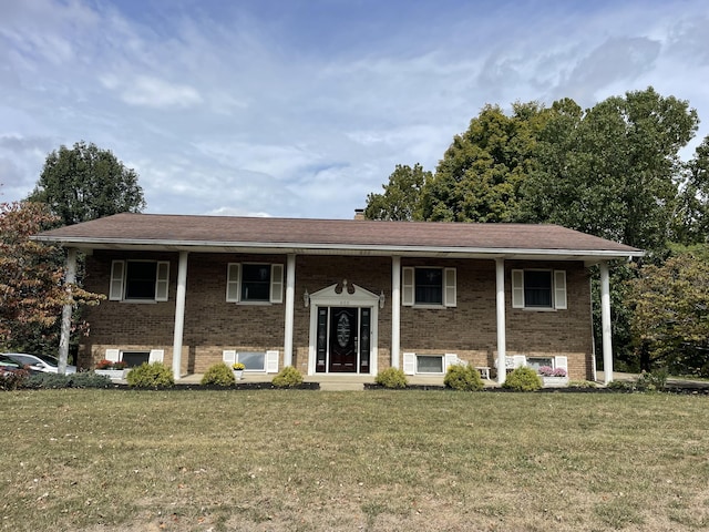 raised ranch with a front yard