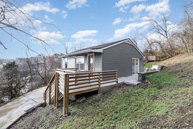 view of home's exterior featuring a wooden deck