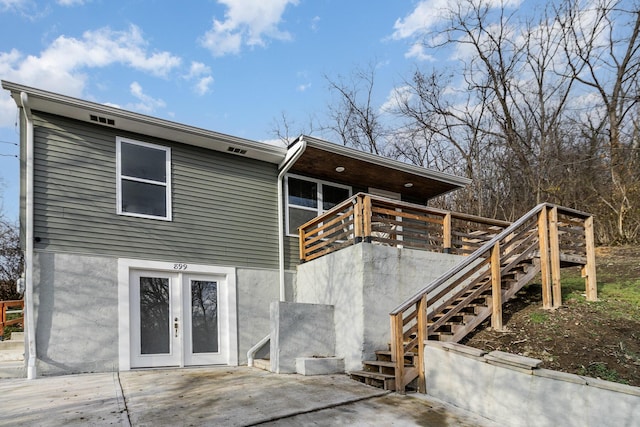 rear view of house featuring a patio area, french doors, and a deck