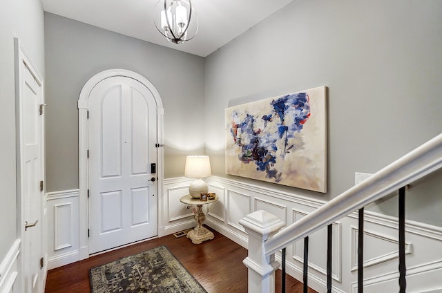 entrance foyer with dark hardwood / wood-style flooring and a chandelier