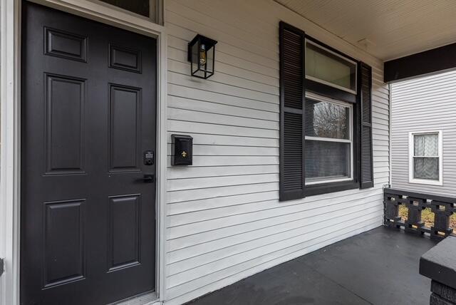 doorway to property featuring covered porch