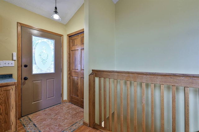 entrance foyer with vaulted ceiling