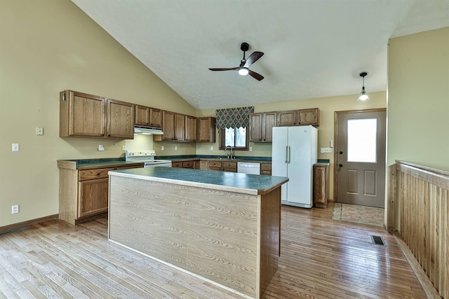 kitchen with white appliances, sink, hanging light fixtures, ceiling fan, and light wood-type flooring