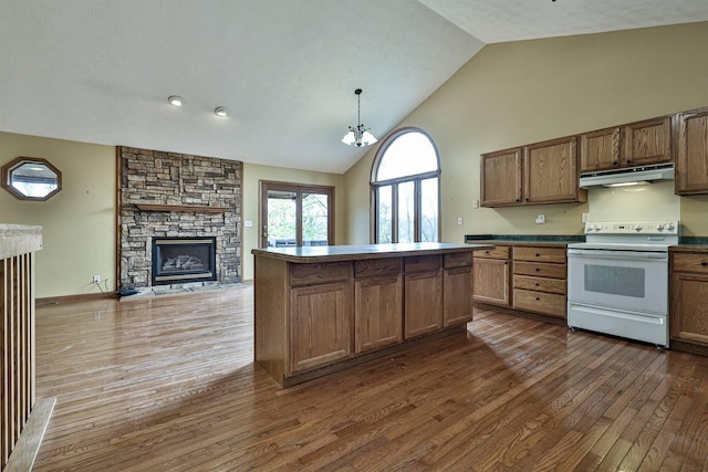 kitchen with dark wood-type flooring, white range with electric stovetop, a chandelier, decorative light fixtures, and a fireplace