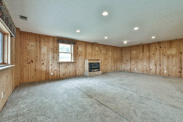 unfurnished living room with carpet and a textured ceiling