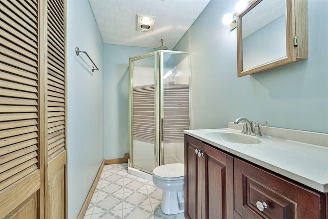 bathroom with vanity, a textured ceiling, toilet, and an enclosed shower