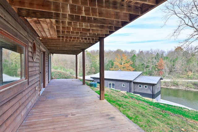 wooden terrace featuring a water view