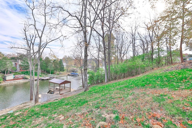 view of yard featuring a water view and a dock