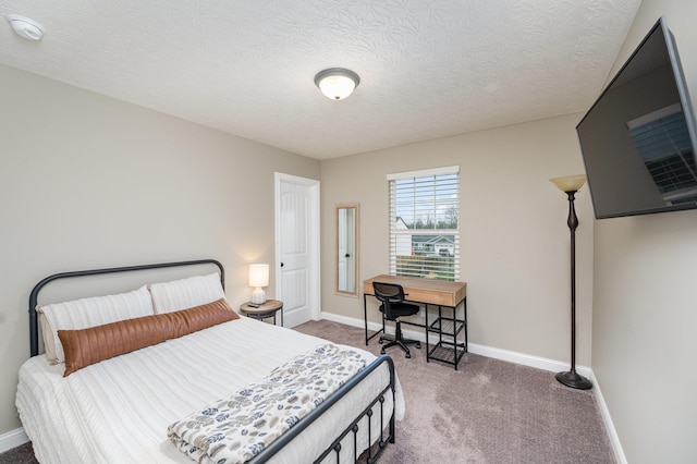 bedroom with carpet flooring and a textured ceiling