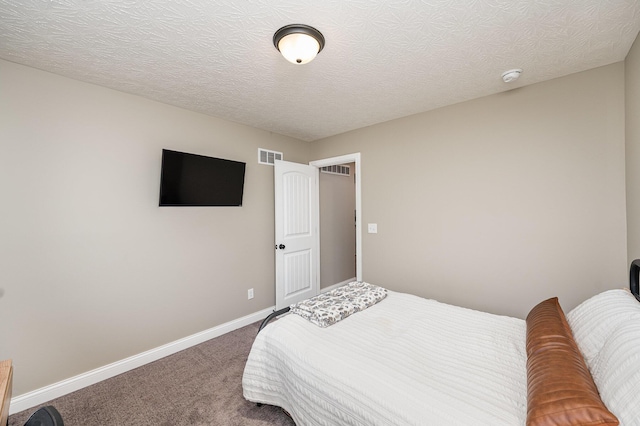 carpeted bedroom with a textured ceiling