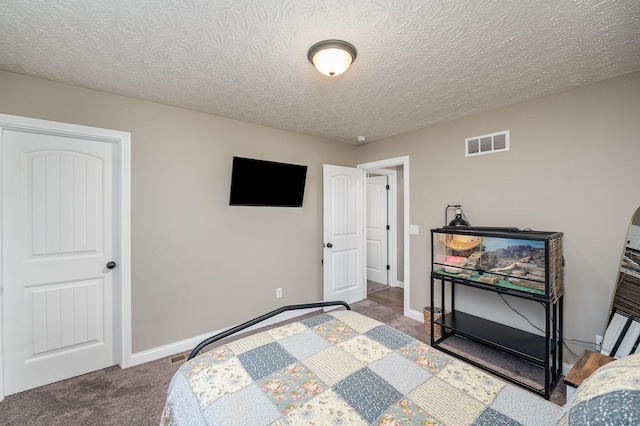 carpeted bedroom with a textured ceiling